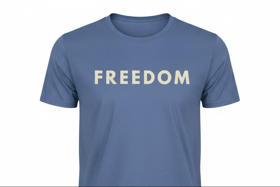 Blue t-shirt with 'FREEDOM' printed on it against a white background